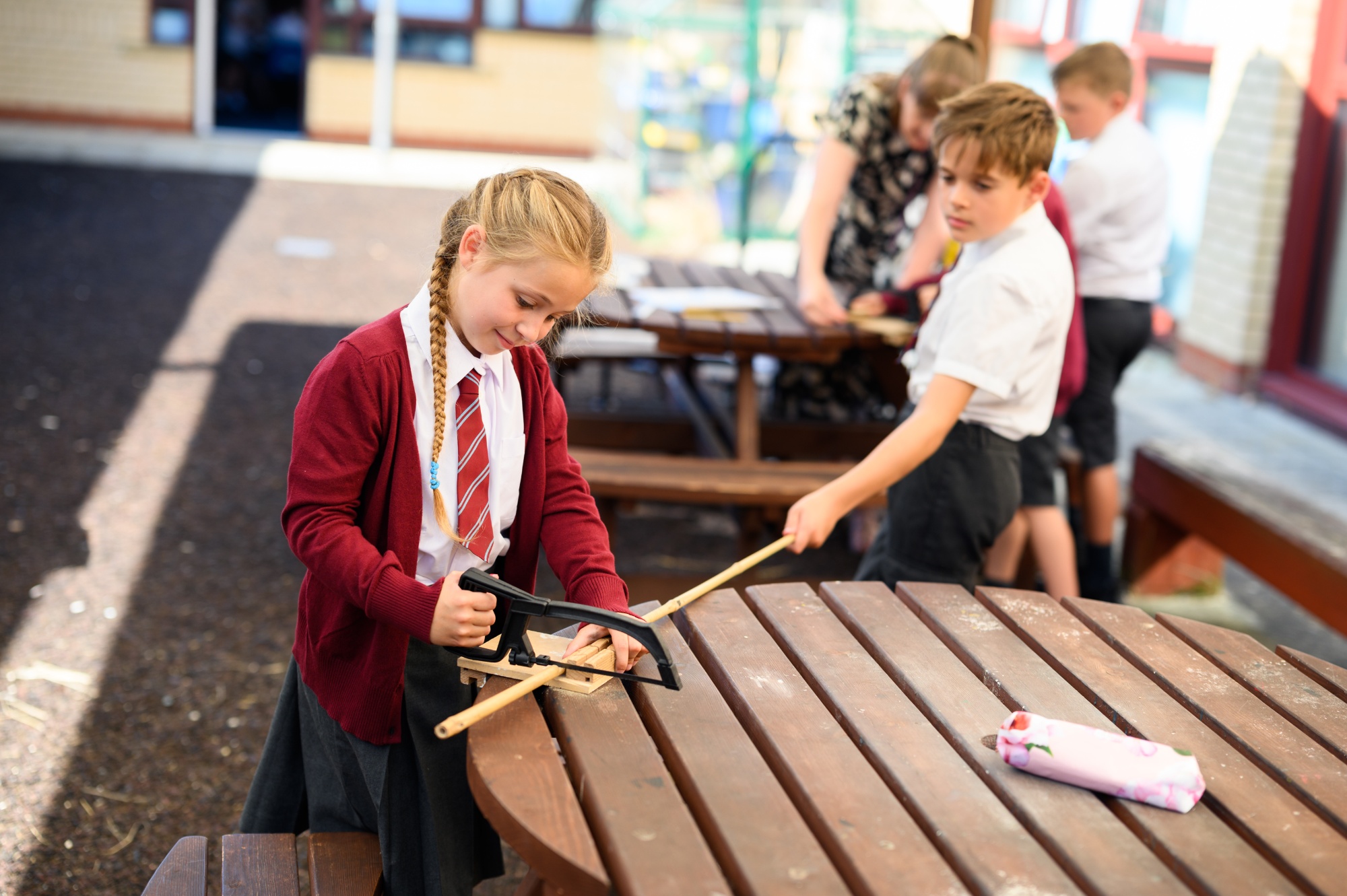 children using a saw in DT lesson